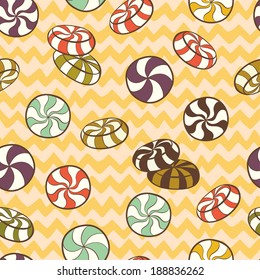 Cute seamless pattern made of hand drawn doodle caramel candies on chevron background. Cartoon sweets background.