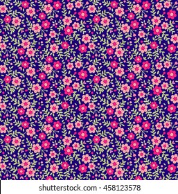 Cute seamless pattern in small flower. Small pink flowers. Dark blue background. Ditsy floral background. The elegant the template for fashion prints.