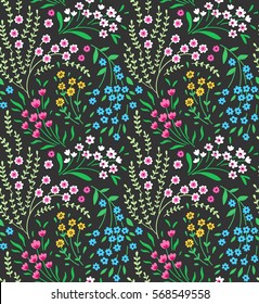 Cute seamless pattern in small flower. Small pink, yellow and blue flowers. Dark green background. Ditsy floral style. The elegant the template for fashion prints.