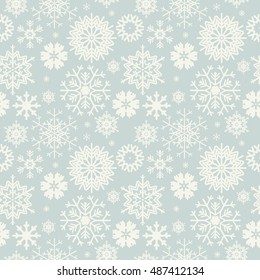 Cute seamless pattern with snowflakes isolated on light blue background.  Winter image for your designs. 