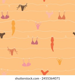 Cute seamless pattern with underwear hanging on a string. Swimsuit, bikini, panties, bra in summer day. Summer time vacation and travel aesthetic. Groovy and fun vector tropical background