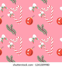 Cute seamless pattern for wrapping Christmas gifts. Christmas tree branch, bow and Lollipop on pink background eps10