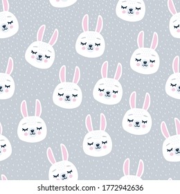 Cute seamless winter pattern with sleeping rabbit heads. Hand drawn background with animal for children, fabric, stationery, clothes and pajamas in the Scandinavian style.