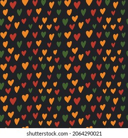 Cute simple Kwanzaa, Black History Month, Juneteenth seamless pattern with hand drawn hearts in traditional African colors -  red, green, yellow on black backdrop. Sweet vector background. Fabric