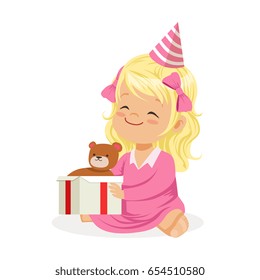 Cute smiling baby girl wearing a pink party hat sitting with gift box. Kids birthday party colorful cartoon character vector Illustratio