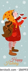 Cute smiling little girl in warm clothing catches snowflakes on your tongue.