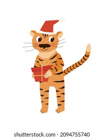 A cute smiling tiger cub with a gift in his paws and a New Year s cap on his head. Vector illustration in a flat style.