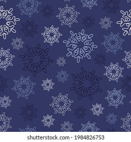 Cute snowflakes on a blue. Seamless pattern. Winter background.