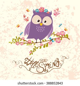 cute spring owl sitting on a flowering branch. Hello spring. the background with splashes.