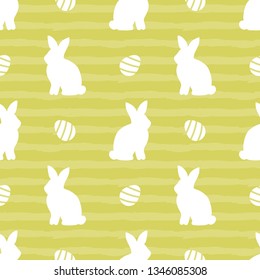 Cute striped seamless pattern background with bunny, rabbit silhouettes and easter eggs for Easter holiday design.
