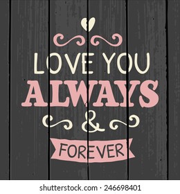 Cute and stylish typographic design for Valentine's Day on a gray wood background.