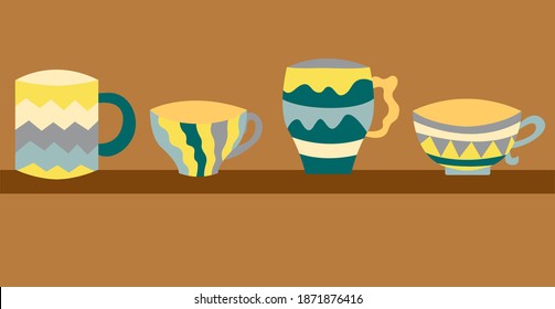 Cute tea cups with geometric pattern. Cups in yellow and grey colors. Cute cups are on the shelf