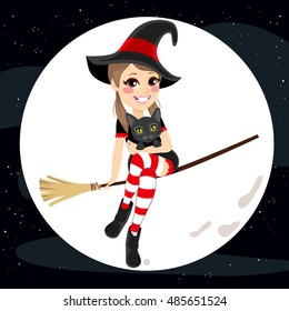 Cute teenager witch holding pet cat flying with broom on full moon Halloween dark night