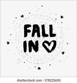 Cute text made of dry brush and ink. Worn brushes ragged texture and circular watercolor dots pattern on the background. Little hearts in a chaotic manner. Text saying Fall in love