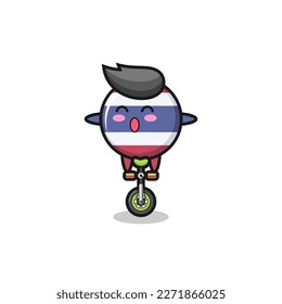 The cute thailand flag badge character is riding a circus bike , cute style design for t shirt, sticker, logo element