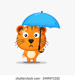 Cute tiger carrying an umbrella