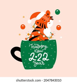 Cute tiger cub is sitting in a cup of coffee. Wild kitty character. Modern poster for prints, kid greeting card, poster, t-shirts. Vector flat illustration with lettering Happy new 2022 year.