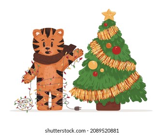 A cute tiger decorates the Christmas tree. The tiger is entangled in a garland. Christmas vector illustration. The symbol of the Chinese New Year 2022. Great for postcards and children's party decorat