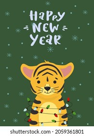 Cute tiger in the doodle style got tangled in a Christmas tree garland. The inscription Happy New Year.
