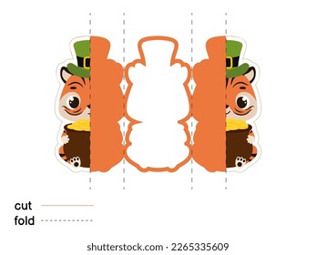 Cute tiger in green leprechaun hat holds bowler with gold coins. Irish holiday folklore theme. Fold long greeting card template. Printable color scheme. Print, cut out, fold. Vector illustration.