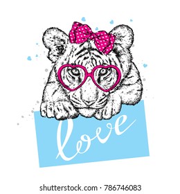 Cute tiger with hearts, glasses and a bow. Vector illustration for a postcard or a poster, print for clothes. Valentine's Day, love and friendship. Tiger cub in clothes and accessories.