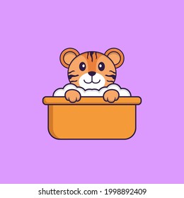 Un tigre dulce bañándose en la bañera. El concepto de caricatura animal aislado. Puede usarse para camisetas, tarjetas de felicitación, tarjetas de invitación o mascota.