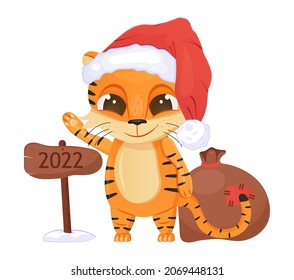 Cute tiger vector. Happy Chinese New Year 2022 symbol. Funny tiger kid with big eyes and santa hat. Christmas invitation card. Bag with gifts and a wooden board with the inscription 2022