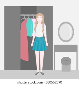 Cute trendy girl is in the room with the wardrobe with clothes and a dressing table. Selection of clothes.