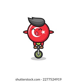 The cute turkey flag badge character is riding a circus bike , cute style design for t shirt, sticker, logo element