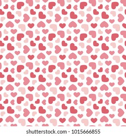 Cute valentine's day seamless pattern background with red and pink hearts.
