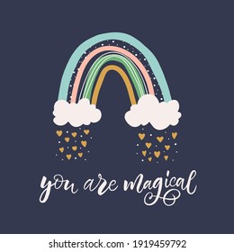 Cute vector illustration. Icon of kawaii rainbow. Hand drawn calligraphy "You are magical". Every element is isolated on dark blue background. Concept for newborn greeting card, baby shower invitation