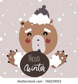 Cute vector illustrator with snowy winter background with cartoon 
 bear blowing kiss wearing hat with pom pom. Cozy winter illustration. Hello winter lettering.