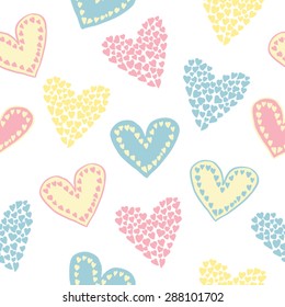Cute vector seamless pattern in blue, yellow and delicate pink colors. Nice hearts drawn in doodle style.