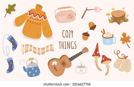 Cute vector set of autumn icons: sweater, falling leaves, cozy socks, candle, pumpkin, mushrooms, ukulele, teapot, radio, scarf. Scrapbook collection of fall season elements. Autumn greeting card