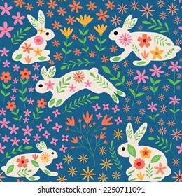 Cute white Bunny rabbits with beautiful whimsical spring flowers seamless pattern in orange, pink, yellow on blue background. For textile, easter fabric and surface textures