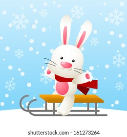 Cute white rabbit on a sled