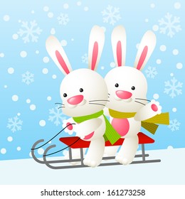 Cute white rabbits on a sled