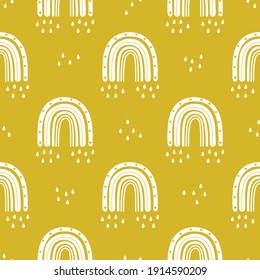 Cute white rainbow with raindrops seamless pattern on yellow background. Kids design elements in vector. Scandinavian baby print. Sky design print for apparel, fabric, wrapping paper