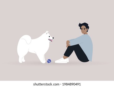 A cute white Samoyed dog playing ball with their owner, human and animal friendship