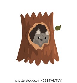 Cute wolf cub sitting in hollow of tree, hollowed out old tree and cute animal cartoon character inside vector Illustration on a white background