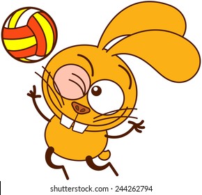 Cute yellow bunny in minimalistic style with big ears, bulging eyes and huge teeth, winking, staring at the ball and jumping high to serve while playing volleyball