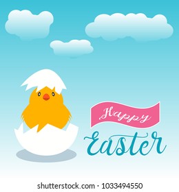 Cute yellow chick hatching from white egg with happy easter message over cloudy blue background