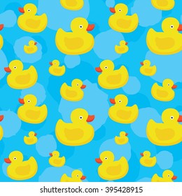 Cute yellow ducks seamless vector pattern on blue background