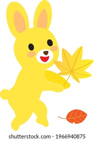 Cute yellow rabbit with the autumn maple