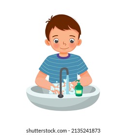 cute young boy washing hands with antibacterial soap and running water under faucet at the sink as prevention against Virus and Infection and personal hygiene