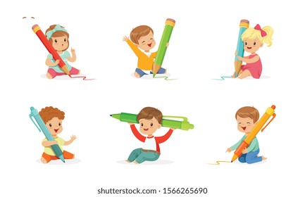 Cute Young Children Holding Big Pencils and Pens