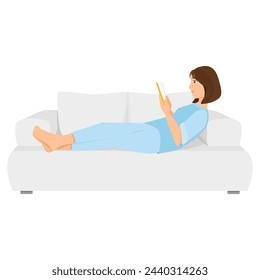 Cute young girl lying on the sofa and reading a book