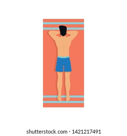 Cute young man in blue shorts take sunbathing on beach