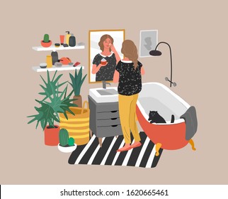 Cute young woman care for her skin, standing in front of mirror, cleansing or moisturizing skin. Daily life skincare routine in bathroom interior with homeplants. Cartoon vector illustration