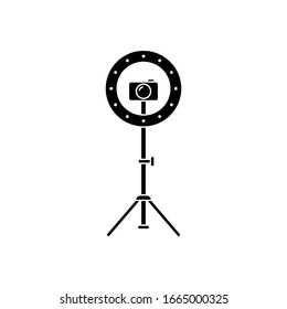Cutout silhouette Led ring lamp on tripod with camera. Outline icon. Black simple illustration of light for selfie, blogger. Flat isolated vector image on white background